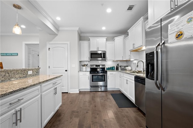 kitchen with visible vents, a sink, appliances with stainless steel finishes, and crown molding