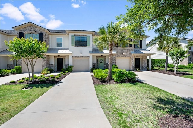 multi unit property with a garage and a front yard