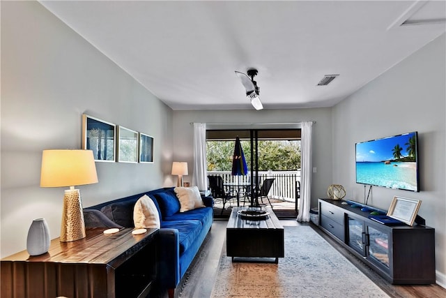 living room featuring wood finished floors and visible vents