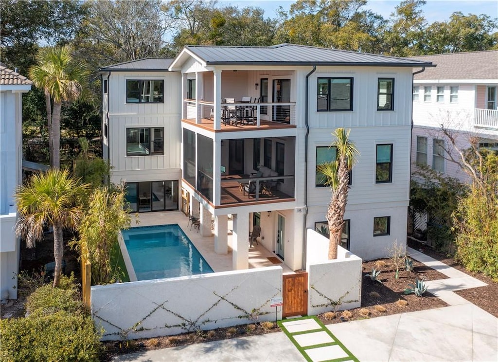 back of house with a balcony and a patio