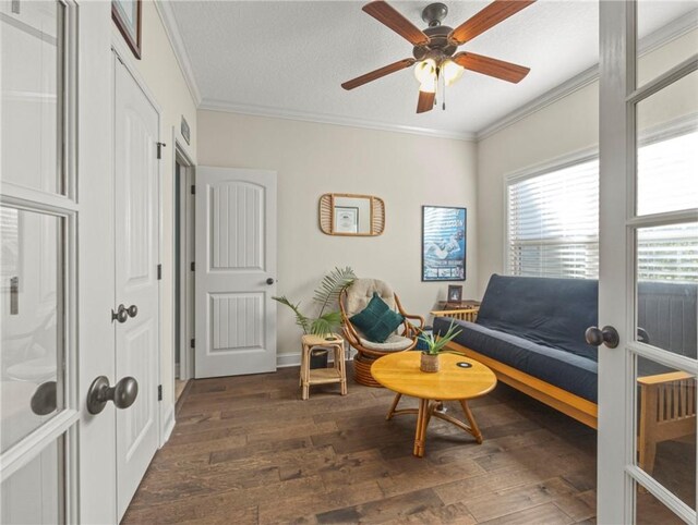 hallway with hardwood / wood-style floors, a textured ceiling, and ornamental molding