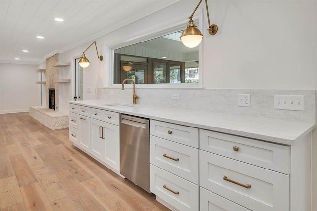 217 Five Pounds Rd, Saint Simons Island, GA 31522 - kitchen with stainless steel dishwasher, a sink, light wood-style flooring, recessed lighting, and white cabinetry
