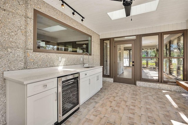 217 Five Pounds Rd, Saint Simons Island, GA 31522 - bar area with wine cooler, a sink, rail lighting, brick patterned floors, and ceiling fan