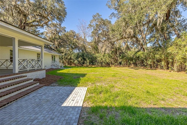 111 Youngwood Dr, Saint Simons Island, GA 31522 - view of green lawn featuring a porch