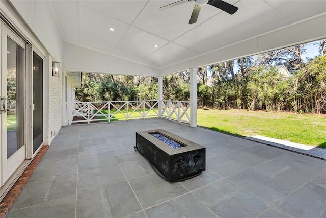 111 Youngwood Dr, Saint Simons Island, GA 31522 - unfurnished sunroom featuring a fire pit, lofted ceiling, a ceiling fan, and healthy amount of natural light