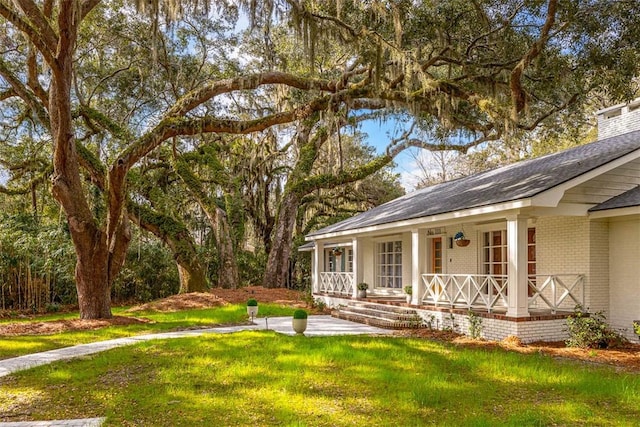 111 Youngwood Dr, Saint Simons Island, GA 31522 - view of green lawn featuring a porch