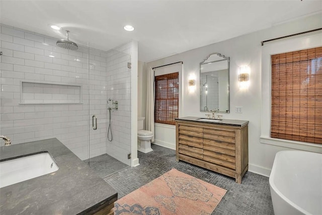 111 Youngwood Dr, Saint Simons Island, GA 31522 - bathroom featuring a stall shower, vanity, tile patterned flooring, a freestanding tub, and recessed lighting