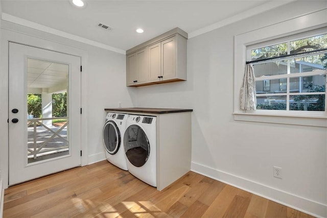 111 Youngwood Dr, Saint Simons Island, GA 31522 - washroom with healthy amount of natural light, washing machine and clothes dryer, light wood-style floors, cabinet space, and recessed lighting