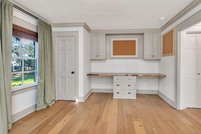 111 Youngwood Dr, Saint Simons Island, GA 31522 - kitchen featuring built in desk, light wood-type flooring, wooden counters, and ornamental molding