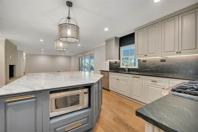 111 Youngwood Dr, Saint Simons Island, GA 31522 - kitchen with appliances with stainless steel finishes, gray cabinets, light wood finished floors, tasteful backsplash, and recessed lighting