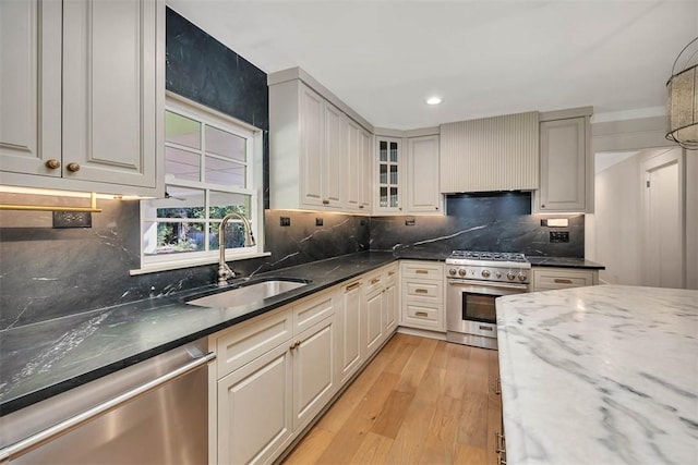 111 Youngwood Dr, Saint Simons Island, GA 31522 - kitchen with appliances with stainless steel finishes, light wood finished floors, dark stone countertops, backsplash, and recessed lighting