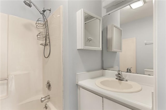 full bathroom with shower / washtub combination, vanity, and toilet