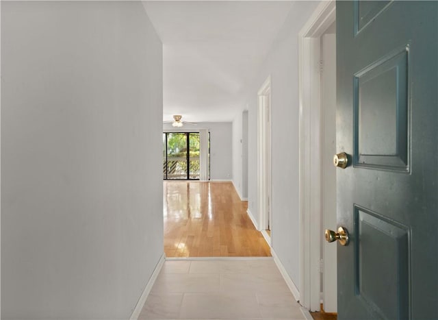 corridor with light hardwood / wood-style floors