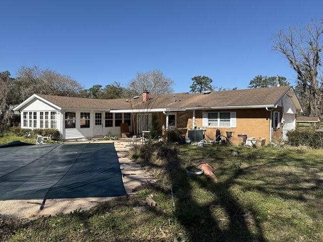 back of house featuring brick siding