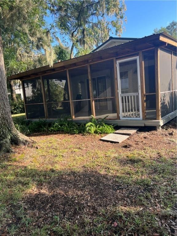 back of property featuring a sunroom