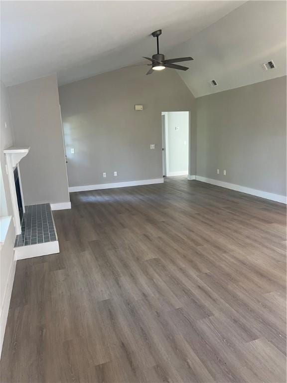 unfurnished living room featuring dark wood finished floors, visible vents, a ceiling fan, a tile fireplace, and baseboards