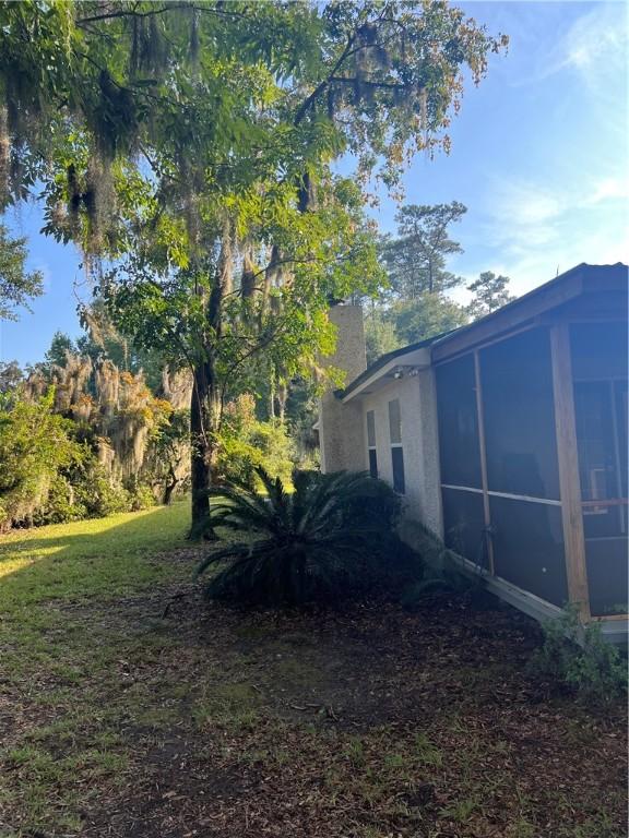 view of yard with a sunroom