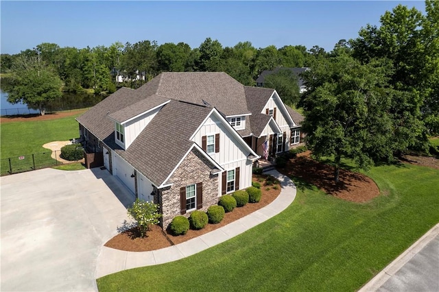 98 Bartram Trl, Brunswick, GA 31523 - view of front of property featuring board and batten siding, concrete driveway, stone siding, a garage, and a shingled roof