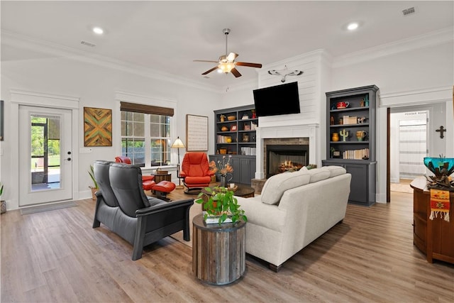 98 Bartram Trl, Brunswick, GA 31523 - living room with a ceiling fan, a lit fireplace, light wood-type flooring, crown molding, and recessed lighting