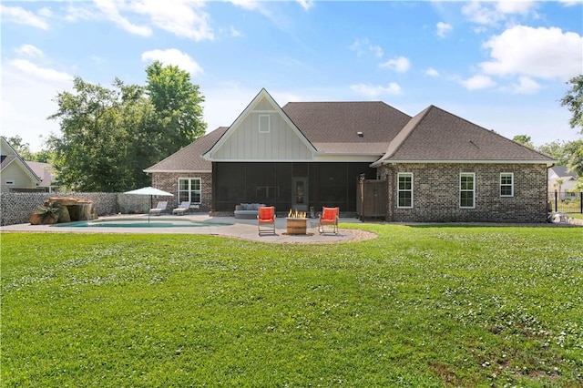 98 Bartram Trl, Brunswick, GA 31523 - rear view of property featuring a fire pit, a patio area, brick siding, and board and batten siding