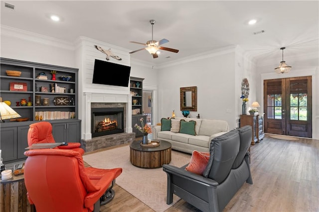 98 Bartram Trl, Brunswick, GA 31523 - living room featuring a ceiling fan, wood finished floors, ornamental molding, recessed lighting, and a warm lit fireplace