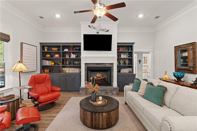 98 Bartram Trl, Brunswick, GA 31523 - living area with wood finished floors, ceiling fan, a large fireplace, crown molding, and recessed lighting