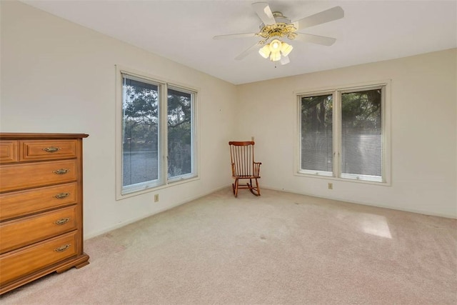 unfurnished room featuring light carpet and ceiling fan