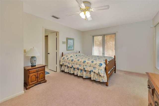 bedroom featuring baseboards, visible vents, and light colored carpet