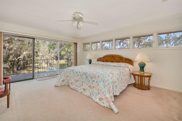 carpeted bedroom featuring access to outside, baseboards, ceiling fan, and a textured ceiling