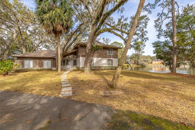 view of front facade with a water view and a front yard