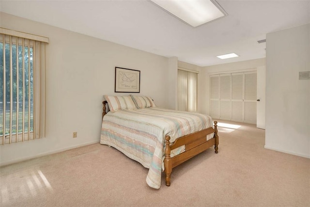 bedroom with light colored carpet, visible vents, and baseboards