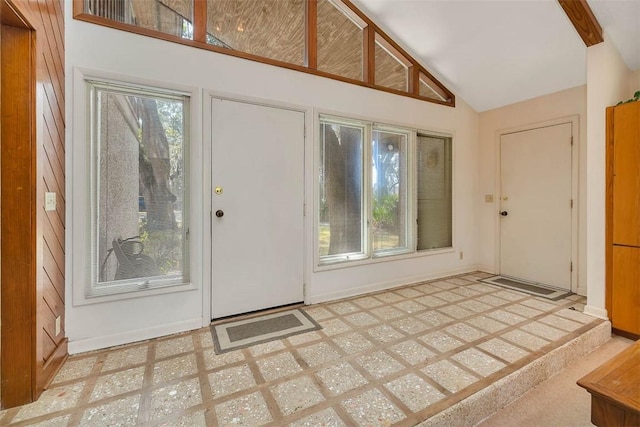 entryway with high vaulted ceiling, visible vents, and baseboards