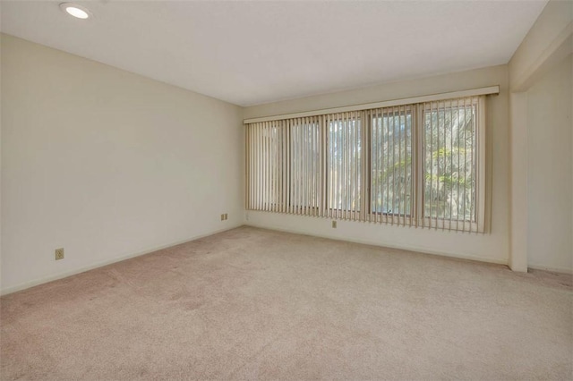 unfurnished room featuring light colored carpet