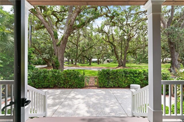 553 Park Ave, Saint Simons Island, GA 31522 - porch featuring view of scattered trees