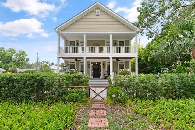 553 Park Ave, Saint Simons Island, GA 31522 - view of front of property with a porch, ceiling fan, a fenced front yard, a gate, and a balcony