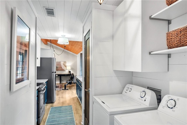 washroom with washer and dryer, light wood-type flooring, and wooden ceiling