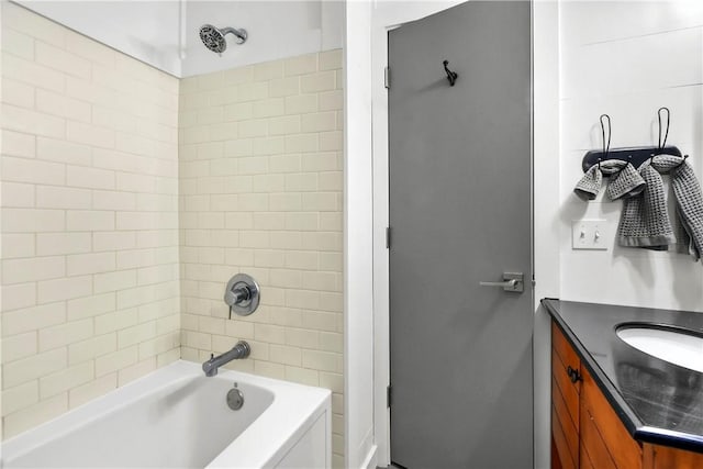 bathroom with vanity and tiled shower / bath combo