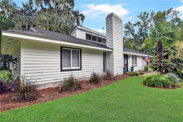 view of side of home with a lawn