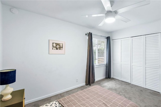 unfurnished bedroom featuring carpet flooring, ceiling fan, and a closet