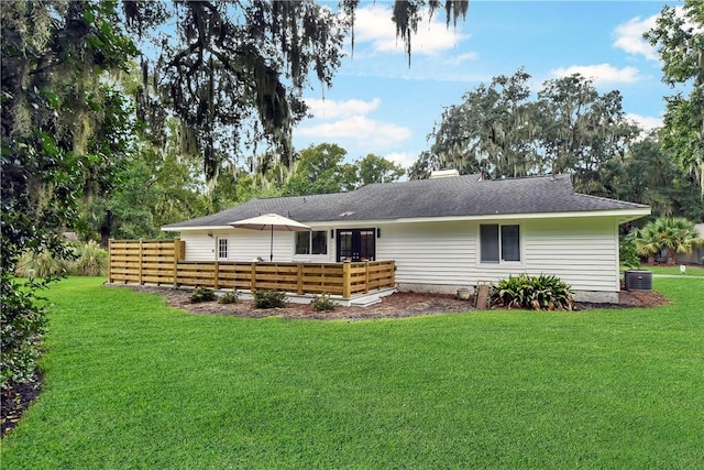 rear view of house featuring cooling unit, a lawn, and a wooden deck