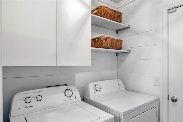 laundry area with cabinets and washing machine and clothes dryer