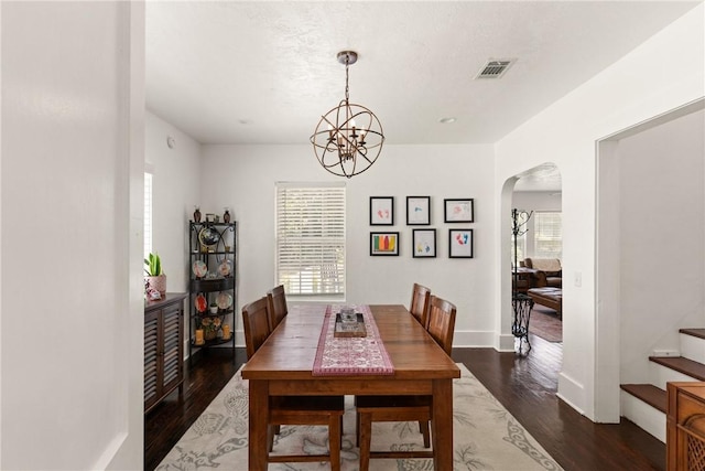 686 S Fourth St, Jesup, GA 31545 - dining space with arched walkways, a chandelier, wood finished floors, and stairway