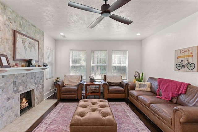 686 S Fourth St, Jesup, GA 31545 - living room with a textured ceiling, ceiling fan, a tile fireplace, wood finished floors, and recessed lighting