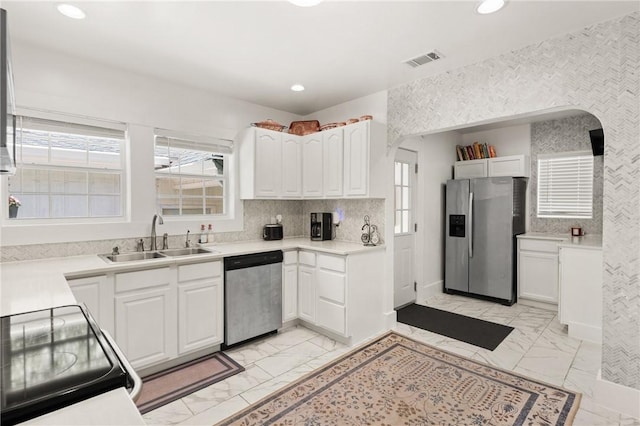 686 S Fourth St, Jesup, GA 31545 - kitchen featuring stainless steel appliances, light marble finish floors, white cabinets, recessed lighting, and healthy amount of natural light