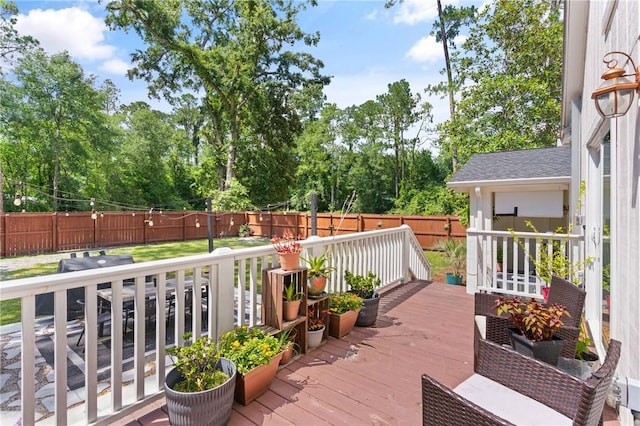686 S Fourth St, Jesup, GA 31545 - wooden deck with a fenced backyard, view of scattered trees, and area for grilling