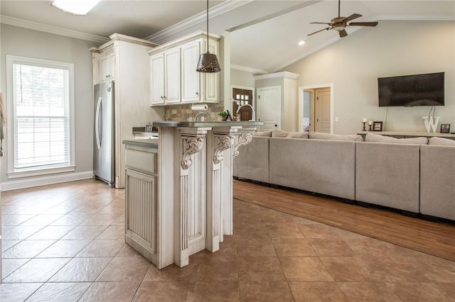 4901 Stanfield Rd, Patterson, GA 31557 - kitchen with open floor plan, freestanding refrigerator, a kitchen breakfast bar, healthy amount of natural light, and ornamental molding