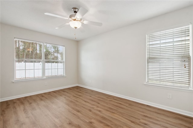 unfurnished room with ceiling fan and wood-type flooring