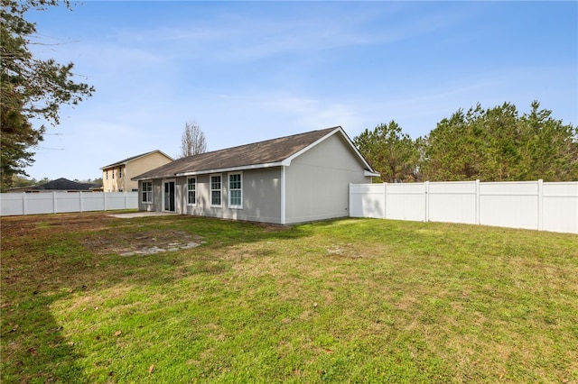 rear view of house with a yard