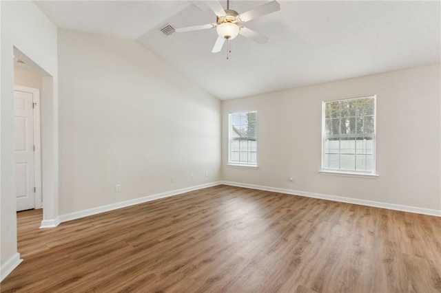 empty room featuring lofted ceiling, light hardwood / wood-style flooring, and ceiling fan