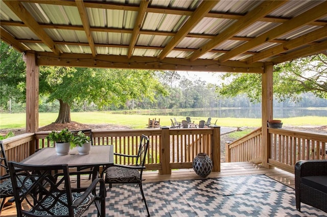 313 White Pine Highway, Nicholls, GA 31554 - wooden terrace featuring outdoor dining area, a lawn, and a water view